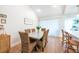 Dining room with a long table, seating for eight, natural light, and access to the kitchen at 3540 Countrybrook Ln # 23, Palm Harbor, FL 34684