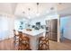Bright kitchen featuring white cabinets, a center island, stainless steel appliances, and a breakfast bar at 3540 Countrybrook Ln # 23, Palm Harbor, FL 34684