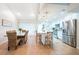 Bright kitchen and dining area with an island, white cabinetry, and stainless steel appliances at 3540 Countrybrook Ln # 23, Palm Harbor, FL 34684