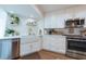 Modern kitchen with white cabinetry, stainless steel appliances, quartz countertops, and luxury finishes at 3540 Countrybrook Ln # 23, Palm Harbor, FL 34684