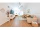 Bright living room featuring white walls, wood-look floors, and cozy seating at 3540 Countrybrook Ln # 23, Palm Harbor, FL 34684
