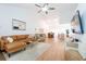 The spacious living room features a vaulted ceiling, wood-look floors, and abundant natural light at 3540 Countrybrook Ln # 23, Palm Harbor, FL 34684