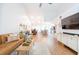 Open concept living space flows into the dining and kitchen area with light wood flooring at 3540 Countrybrook Ln # 23, Palm Harbor, FL 34684