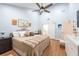 Spacious main bedroom with a ceiling fan, hard wood floors, and access to the en suite bathroom at 3540 Countrybrook Ln # 23, Palm Harbor, FL 34684