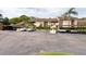 Well-maintained parking lot with covered parking spaces and lush landscaping at 3540 Countrybrook Ln # 23, Palm Harbor, FL 34684