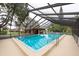 A covered community pool with patio is the focal point in this image at 3540 Countrybrook Ln # 23, Palm Harbor, FL 34684