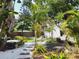 Lush backyard featuring tropical landscaping, various seating areas, and a storage shed at 3545 7Th N Ave, St Petersburg, FL 33713