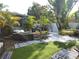 Cozy backyard seating area features artificial turf, tropical plants, and stylish outdoor furniture at 3545 7Th N Ave, St Petersburg, FL 33713