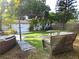 Spacious backyard with artificial turf, a seating area, a white fence, and lush tropical landscaping at 3545 7Th N Ave, St Petersburg, FL 33713