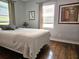 Relaxing bedroom with hardwood floors, light walls, and two windows with blinds at 3545 7Th N Ave, St Petersburg, FL 33713