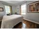 Relaxing bedroom with hardwood floors, light walls, and two windows with blinds at 3545 7Th N Ave, St Petersburg, FL 33713