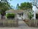 Charming single-story home featuring a well-maintained lawn and inviting front porch and quaint picket fence at 3545 7Th N Ave, St Petersburg, FL 33713