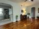 Bright living room with archways, hardwood floors, and views into the kitchen and entryway at 3545 7Th N Ave, St Petersburg, FL 33713