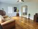 Comfortable living room featuring original hardwood floors, ceiling fan, and natural light at 3545 7Th N Ave, St Petersburg, FL 33713