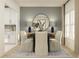Elegant dining room with a modern table setting, accent lighting, and a calming color palette for sophisticated meals at 3576 Silent Gardens Cv, Wesley Chapel, FL 33543