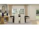 Serene dining area featuring a stylish table setting, complemented by natural light, and elegant décor at 3576 Silent Gardens Cv, Wesley Chapel, FL 33543