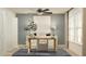 Stylish home office featuring a spacious desk, ample natural light, and contemporary decor for a productive environment at 3576 Silent Gardens Cv, Wesley Chapel, FL 33543