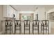 Modern kitchen with counter seating and stylish bar stools, providing an inviting space for casual dining and entertaining at 3576 Silent Gardens Cv, Wesley Chapel, FL 33543