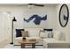 Cozy living room featuring a comfortable white couch, stylish decor, and a ceiling fan for added comfort at 3576 Silent Gardens Cv, Wesley Chapel, FL 33543
