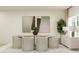 Elegant dining area with an oval table, comfortable chairs, and tasteful wall art at 3584 Silent Gardens Cv, Wesley Chapel, FL 33543