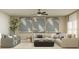 Inviting living room with large sectional, comfortable seating, and natural light at 3584 Silent Gardens Cv, Wesley Chapel, FL 33543