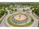 Aerial view of a neighborhood roundabout with fountains and professional landscaping at 4365 Frontera Ln, Wesley Chapel, FL 33543