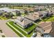 Aerial view of a residential neighborhood near a lake showcasing yards and homes at 4365 Frontera Ln, Wesley Chapel, FL 33543