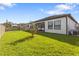 Spacious backyard with manicured lawn, privacy fence, and covered patio seating area at 4365 Frontera Ln, Wesley Chapel, FL 33543