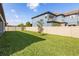 Expansive backyard features lush green grass, a privacy fence, and young trees at 4365 Frontera Ln, Wesley Chapel, FL 33543