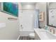 Bright bathroom featuring tiled shower-tub, framed art and vanity with sink at 4365 Frontera Ln, Wesley Chapel, FL 33543