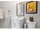 Stylish half bathroom featuring a white vanity, modern fixtures, and an elegant mirror at 4365 Frontera Ln, Wesley Chapel, FL 33543