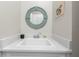 Bathroom sink with white countertop, round mirror, and bright, natural lighting at 4365 Frontera Ln, Wesley Chapel, FL 33543