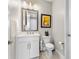Bathroom featuring a white vanity, marble floors, framed mirror, and elegant artwork at 4365 Frontera Ln, Wesley Chapel, FL 33543