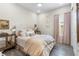 Comfortable bedroom with wood-look flooring, soft pink accents, and ample natural light from the window at 4365 Frontera Ln, Wesley Chapel, FL 33543