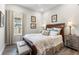 Charming bedroom with wood-look floors, a classic wooden bed frame, and natural light from the window at 4365 Frontera Ln, Wesley Chapel, FL 33543