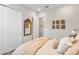 Comfortable bedroom features a cozy bed, a golden mirror, and neutral walls at 4365 Frontera Ln, Wesley Chapel, FL 33543