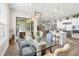 Bright dining area featuring a glass table and view of the outdoor patio and modern, open-concept kitchen at 4365 Frontera Ln, Wesley Chapel, FL 33543