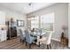 Dining room with glass table, modern chairs, and a wine fridge at 4365 Frontera Ln, Wesley Chapel, FL 33543