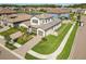 Aerial of an attractive two-story home, showcasing landscaping, hardscape, and a three car garage at 4365 Frontera Ln, Wesley Chapel, FL 33543