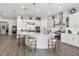 Beautiful kitchen boasts white cabinets, stainless steel appliances, and a large central island with barstool seating at 4365 Frontera Ln, Wesley Chapel, FL 33543