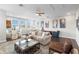 Open concept living room with hardwood floors, large windows and comfortable seating arrangements at 4365 Frontera Ln, Wesley Chapel, FL 33543