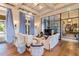 Cozy living room featuring wood floors, custom window treatments, and comfortable seating, ideal for relaxation at 4365 Frontera Ln, Wesley Chapel, FL 33543