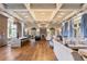 Spacious lounge with a marble island, stone fireplace, wood flooring and large windows offering ample seating at 4365 Frontera Ln, Wesley Chapel, FL 33543