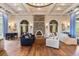 Inviting lounge area with stone fireplace, piano, and ample seating, perfect for gatherings and relaxation at 4365 Frontera Ln, Wesley Chapel, FL 33543