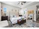 A serene main bedroom featuring a tufted headboard, area rug, and ensuite bathroom with soaking tub at 4365 Frontera Ln, Wesley Chapel, FL 33543