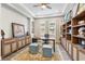 Home office features wooden desk and shelving, unique decor, and natural light at 4365 Frontera Ln, Wesley Chapel, FL 33543