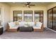 Comfortable outdoor patio with a large sectional, ceiling fan, and sliding glass doors at 4365 Frontera Ln, Wesley Chapel, FL 33543