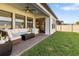 Covered patio with comfortable seating, ceiling fan, and view of the backyard at 4365 Frontera Ln, Wesley Chapel, FL 33543