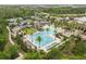 Aerial shot of a community pool surrounded by palm trees, lounge chairs, and amenities at 4365 Frontera Ln, Wesley Chapel, FL 33543