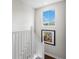 Bright stairwell with white railing, dark wood floors, and natural lighting at 4365 Frontera Ln, Wesley Chapel, FL 33543